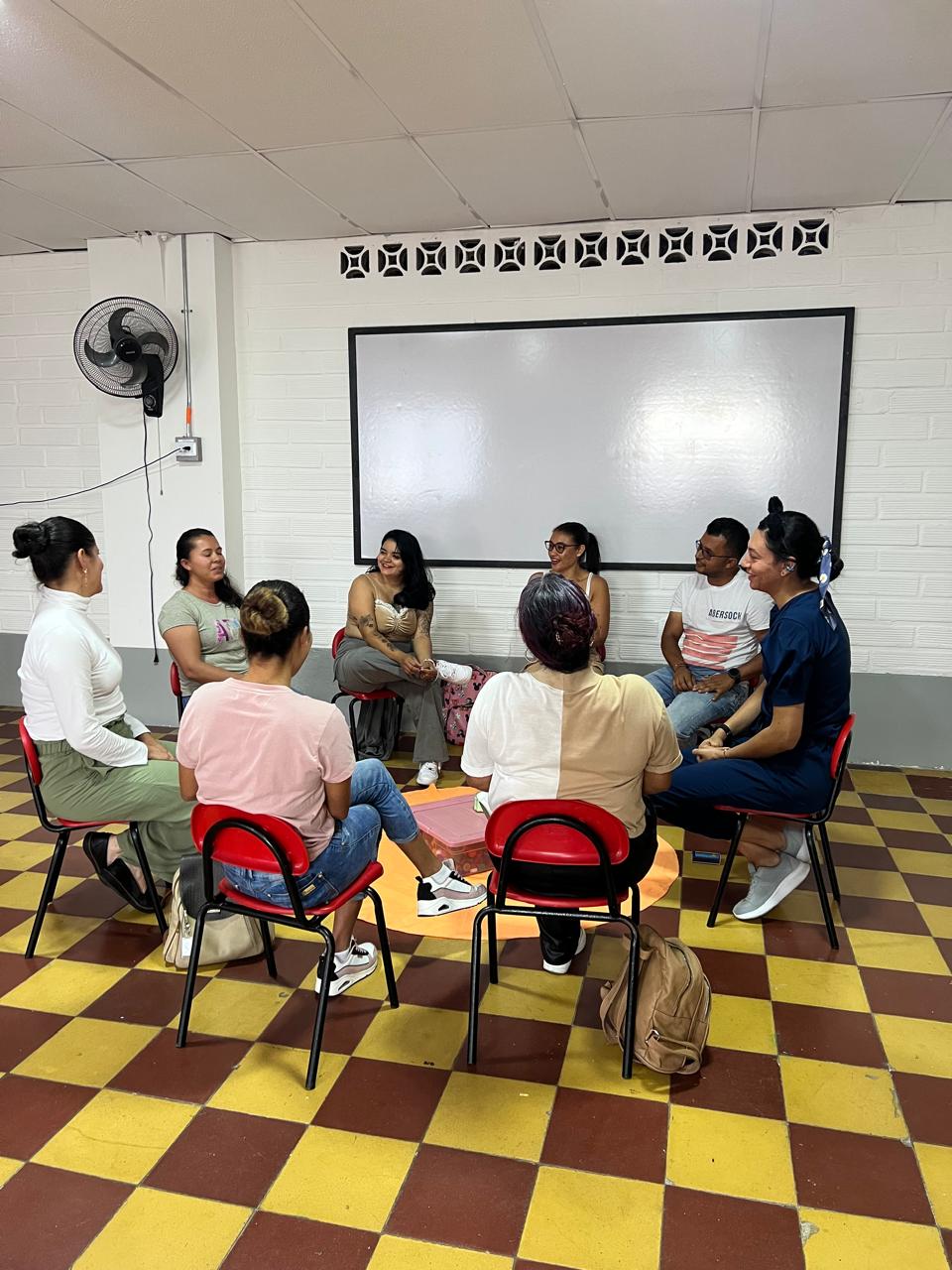 Grupo de personas reunido recibiendo orientación psicosocial